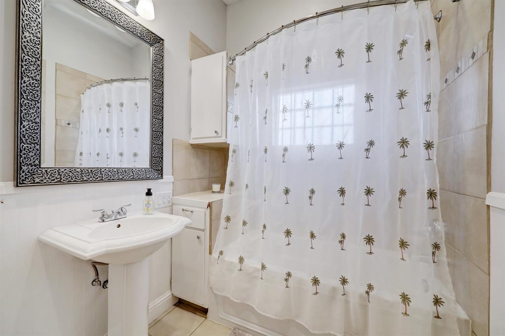 Second full bathroom located in between bedrooms with shower/tub combination.