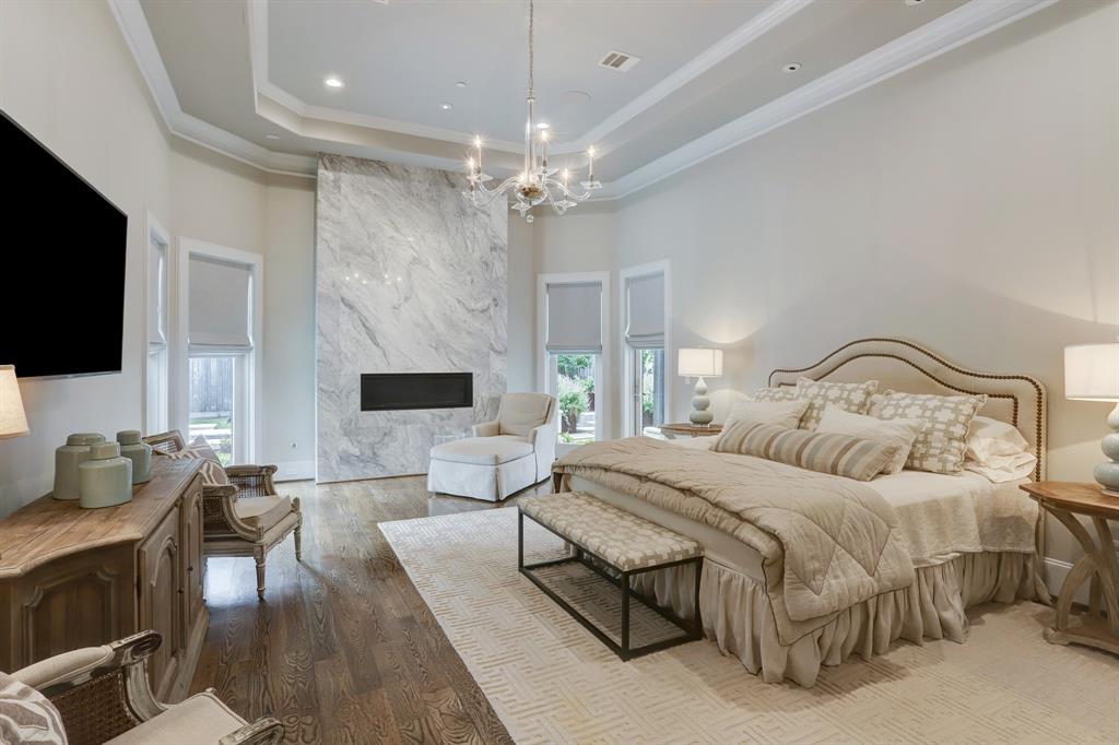 Primary suite with marble fireplace and electric shades