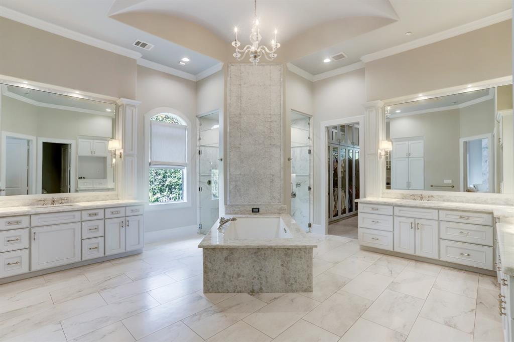 Stunning Primary bath with marble throughout, separate closets and large soaking tub with light and sound features