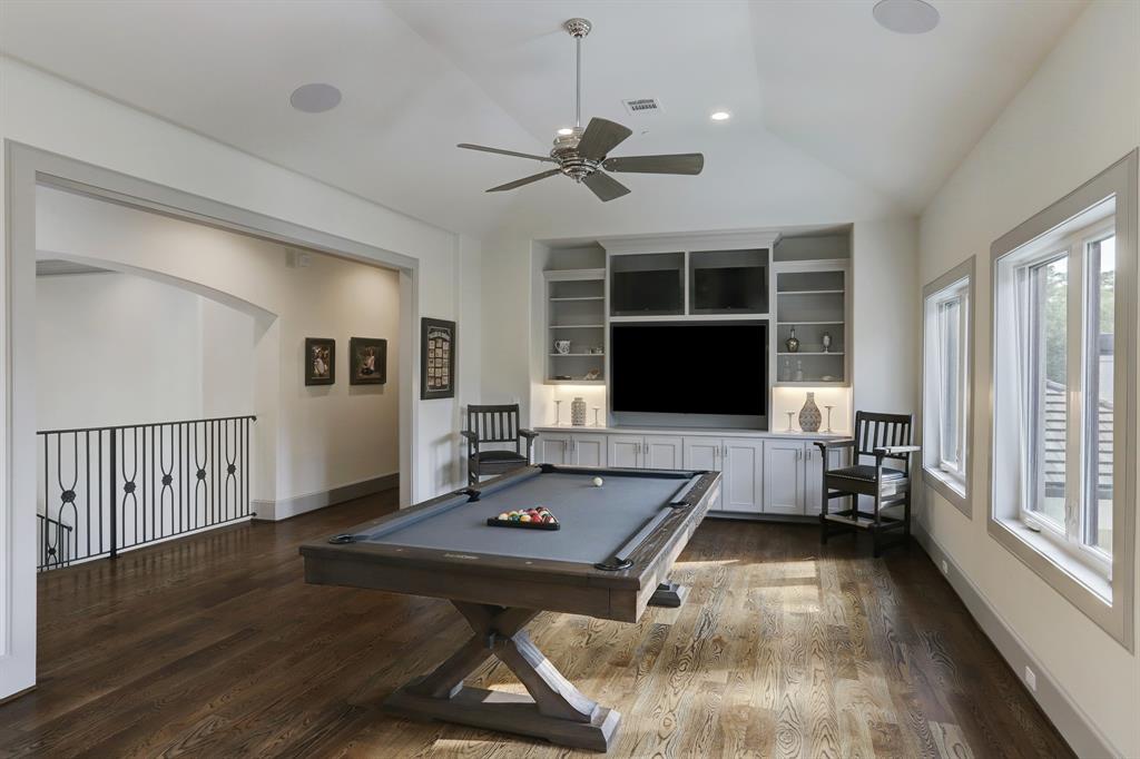 Large game room with 3 televisions and a bonus area