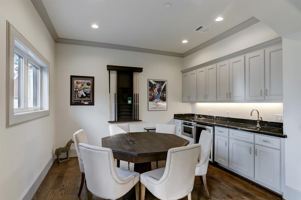 Upper area of game room with a sink wine refrigerator and microwave
