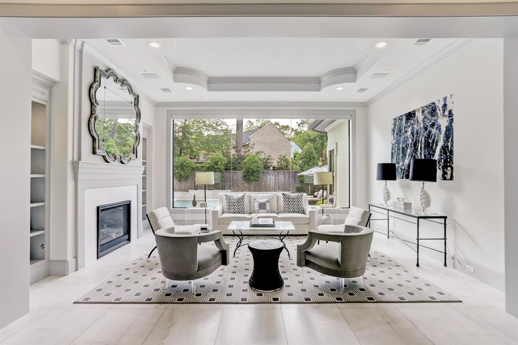 Fabulous formal sitting room with fireplace overlooking pool