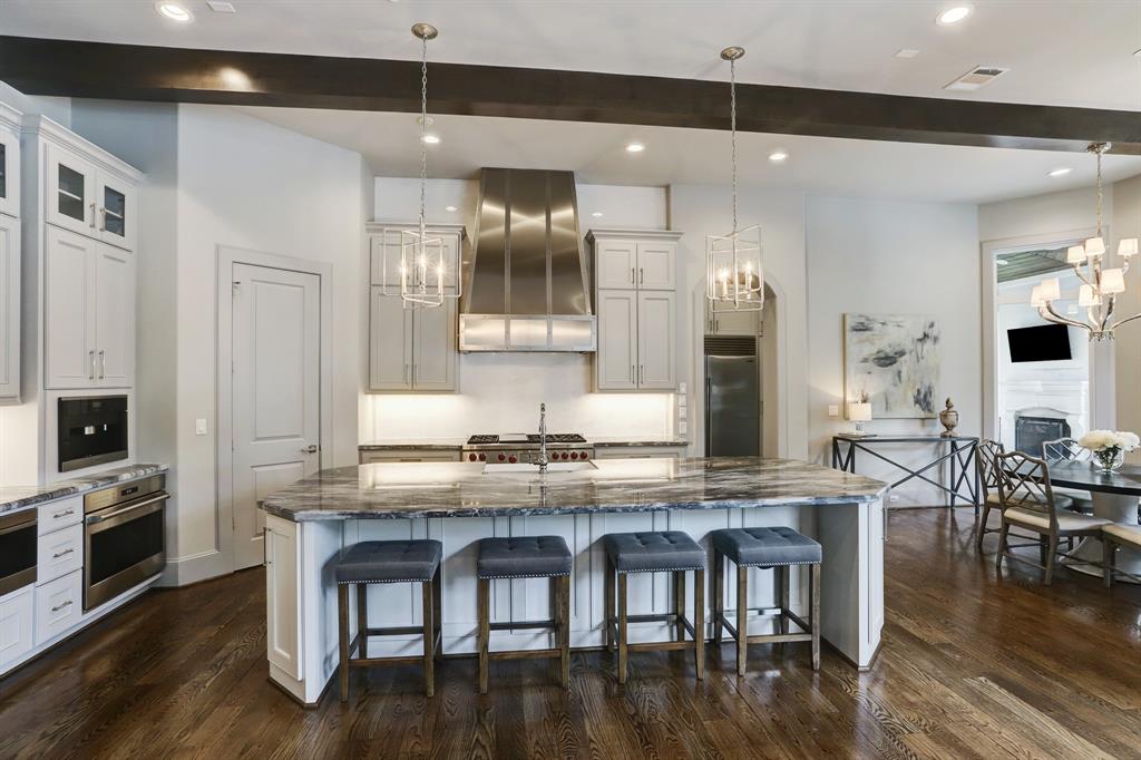 Gourmet Kitchen featuring marble counters, Sub-Zero refrigerator/freezer 3 wolf ovens, 2 bosch dishwashers, Miele coffee system, wolf range with 6 burners and a griddle
