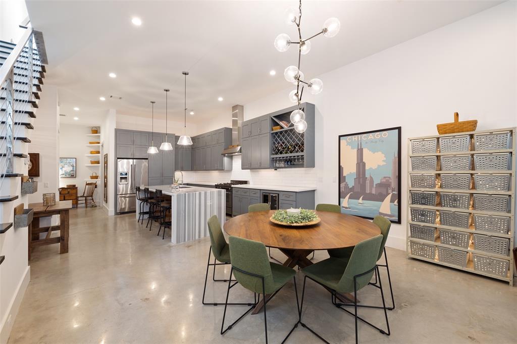 The dining space is open to the kitchen and the living area, which includes a gorgeous chandelier.