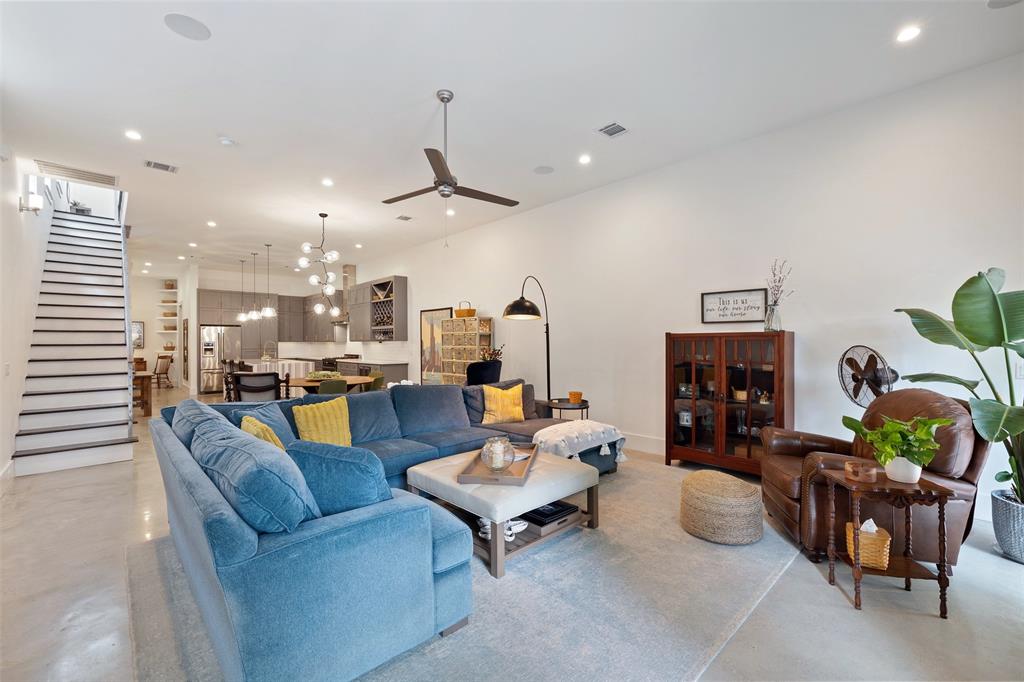 The living room has plenty of space for this large sofa sectional. It also includes built-in speakers and concrete floors. This main floor includes 11 foot ceilings and gorgeous polished concrete floors throughout.