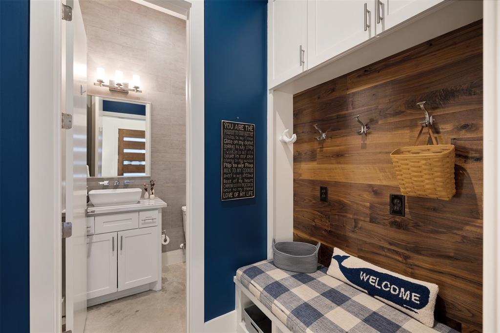 This mudroom area is located just off the 2 car garage. It includes built-in cabinetry and the walnut accent siding.