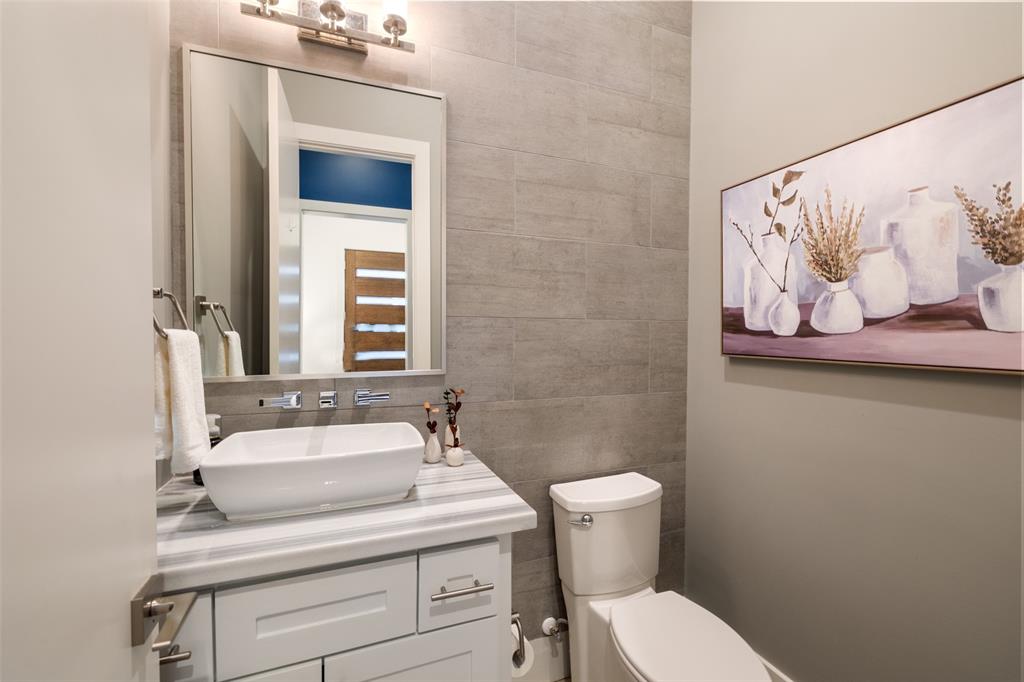 The first floor also includes this beautiful half bathroom, located just off the mudroom. It includes marble counter-tops and a wall mounted faucet.