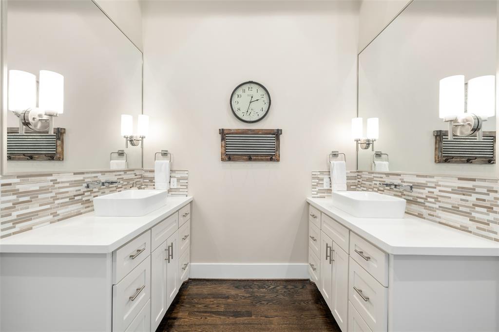 The primary bathroom also includes double vanities with lots of storage and quartz countertops.