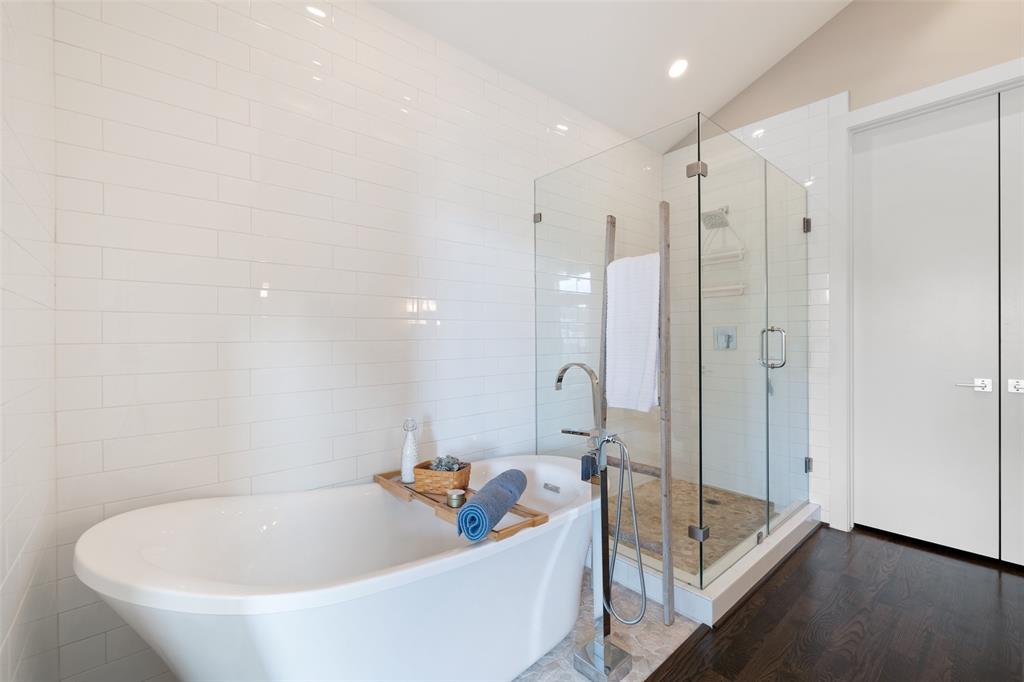 The primary bathroom includes a stand alone soaking tub and huge seamless shower.