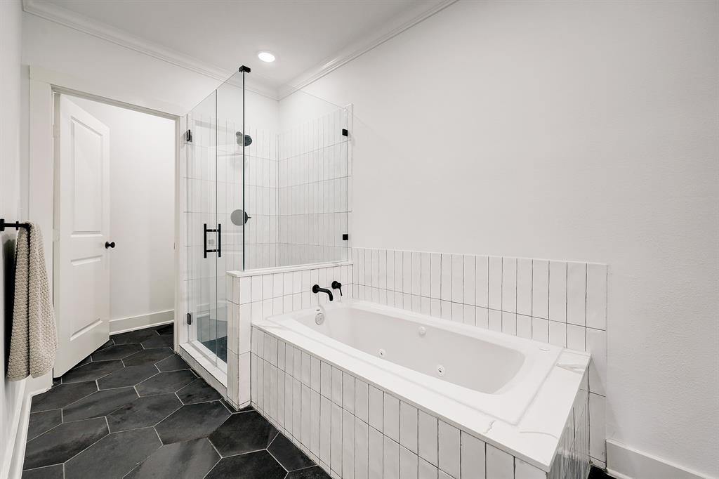Completing the primary bath are a jetted tub, separate frame-less glass shower and private water closet, an exceptional bungalow bathroom!