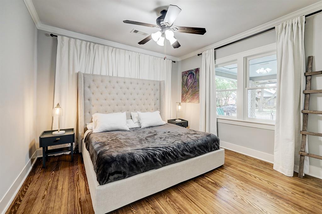 Of two secondary bedrooms, this one sits at the front of the home looking out on the front porch and tree lined 16th St. It very comfortably accommodates a king sized bed with nightstands. Outside the picture frame to the right of the ladder is a spacious closet. The drapes in this bedroom are also 