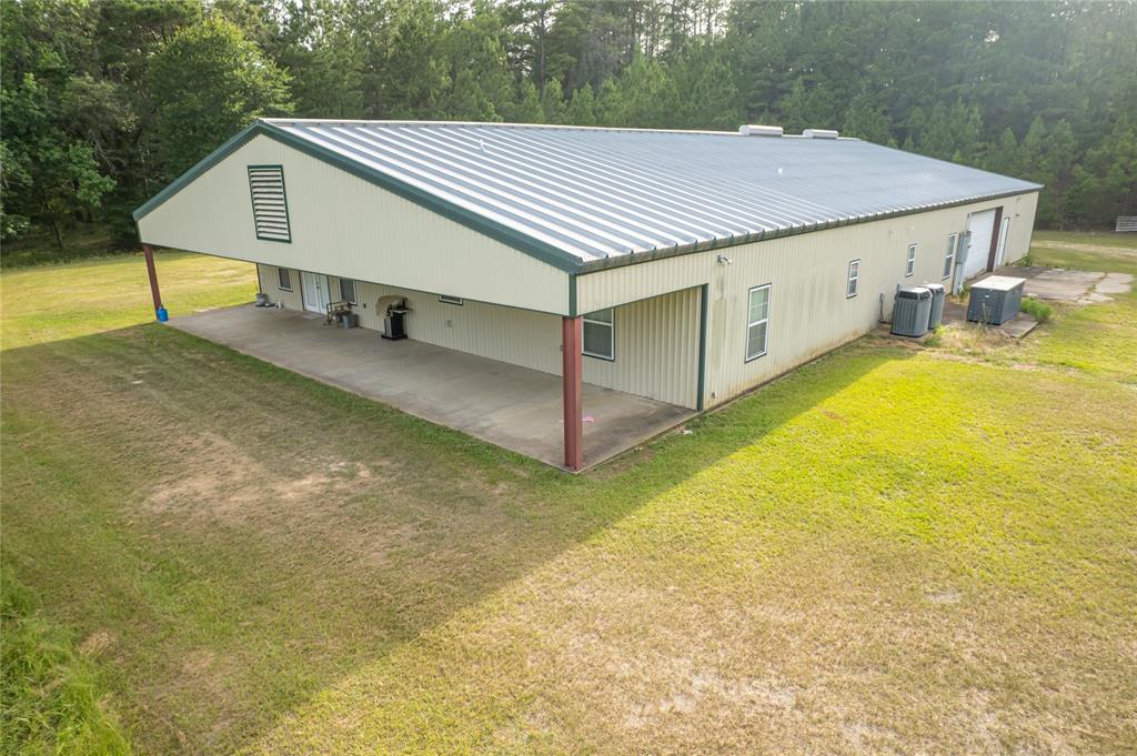 Outdoorsman Dream Property!!  3000 sq foot Barndominium on 242 fenced acres with a 52x38 Shop!  A solar powered gate will welcome guests and provide security from unwanted.  Driving down the tree lined driveway will open up to a cleared area where the home sits.  Inside the home, you have 3 large bedrooms with 3 large bathrooms.  A fantastic kitchen greets you with a breakfast bar and moveable island.  There is plenty of storage in the kitchen with 8 pullout drawers and 9 additional cabinets.  The island also has 4 cabinets for storage. Large walk-in pantry with shelving.  All appliances stay including washing machine and dryer.   The 22x13 laundry room has plenty of room for your deep freezers.  Commercial grade hot water heater.  Water softener.   Generator that run the entire home.  Two Trane HVAC units.  Fruit trees.  Massive shop with small air conditioned room.  Come hunt or fish on Box creek that runs through the property.  Enjoy the outdoors and privacy on your own land.