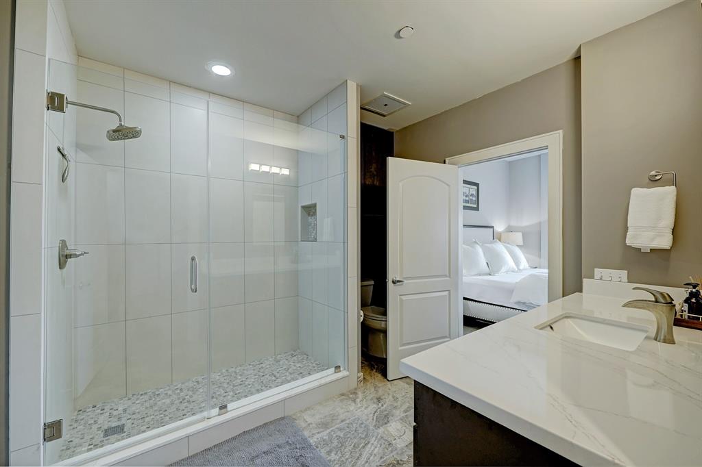 Huge seamless shower. Handsome fixtures. View of 1st Floor Bedroom.