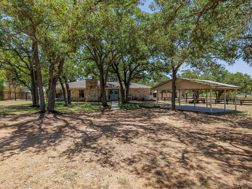 Featuring 10.01 acres w/3/3 - 2,386 sqft. newly-remodeled home and top-of-the-line horse facilities!
Clusters of mature oak trees shade the ranch-style home and unattached two-car carport, w/super backyard entertainment spaces AND everything needed for horses, steer roping and riding; 90'x40' 9-stall barn/stables w/indoor wash rack, feed/tack rooms, round pen w/walker, metal-panel arena w/CHUTE HELP™ - fully automatic, solar-powered roping chute, 2nd barn w/3 pipe pens/storage loft/equipment storage room, portable-building workshop, chicken coop & new playscape! Gated entrance leads to this turnkey property with retro-feeling double doors opening into the remodeled LR featuring a wood-burning fireplace, dry bar, built-ins and rich finishes in the open-concept Living, Dining Area and Kitchen, 3 large bedrooms w/Ensuite baths and a bonus-living area w/barn doors. Outdoor features are just steps away from the house and overlook the horse facilities, open pasture, ponds and roping arena.