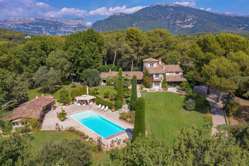 This extraordinary estate offers the best in elegance, discretion, space, and peacefulness. Located on the top of a hill with views of the countryside, the Alps, and the Mediterranean Sea, the property offers total privacy. There are 4 separate houses and numerous annexes incorporated with the property. In addition to the main house made of stone with its own tower that offers sea views, there is a guest house and an artist house.  Each house features at least one fireplace. The estate includes a tennis court, summer kitchens, 9 in total, a pool house, ponds, fountains, a pizza oven, a boule court, a hammock house, and several workshops. There are 2 wells on the property that provide water for the park. There are more than a dozen bedrooms, a helicopter landing area, 3 golf courts, 60 olive trees, an oak forest, and a tennis court. the grounds incorporate 676,333 sq-ft, 15.53 acres. The property is 12 km inland from the Mediterranean coast and equidistant from Nice, Antibes, Cannes.