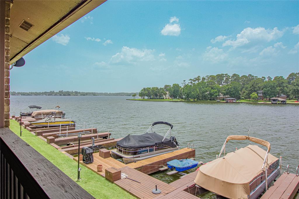 FEEL LIKE YOU ARE ON VACATION EVERY DAY at this scenic location on Lake Conroe! Situated on a point, and surrounded by LAKE on 3 sides, this property is absolutely one of a kind with million dollar views for the best waterfront pricing on Lake Conroe! Featuring its very own boat slip, a private pool for condo residents, gated entry, and fantastic water views right out the back balcony, a peaceful lake life is just around the corner! You'll also appreciate ample green space to enjoy picnics and take in the views. The location here is not only scenic, but it's very quiet and peaceful away from the hustle and bustle of life. While you are away from it all you are still only a short drive from Hwy 105 and all that Montgomery & Conroe have to offer, you will never run out of things to do, places to eat, and services you need daily. It's rare to have all of this at this price point, but to also have your own boat slip to go with it is amazing. Be on the lake in minutes! Come and get it!