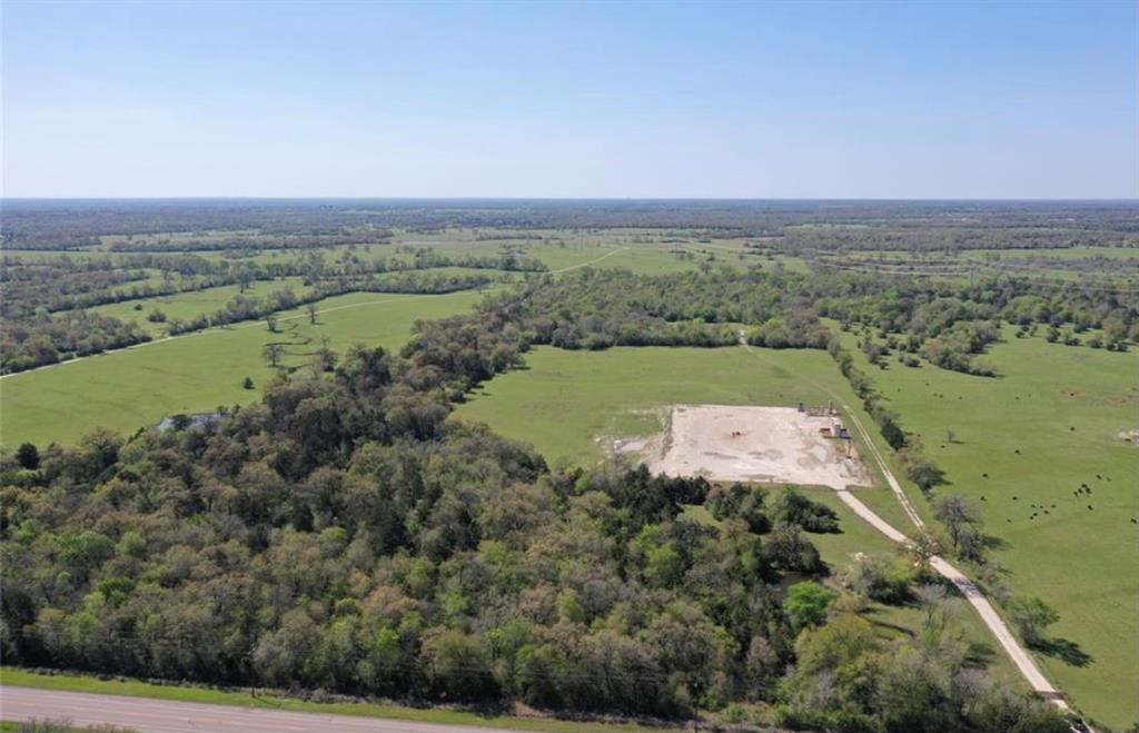 Tract 1 with oilwell pad - Offering 36.82 +/- acres conveniently located on Aggie Highway State HWY 21 between Madisonville and Bryan/College Station. Gorgeous partially wooded ranch located 9 miles West from downtown Madisonville with excellent road frontage with a small pond toward the front of the land and beautiful creek in the back of property. Major new improvements include land clearing in front pasture, new net wire fence around perimeter with pipe post and double gated entrance with black pipe fence. Great ranch or new home location located within a 30-minute drive from Bryan/College Station. A must-see property with these new improvements. Property can be spilt into various configurations by seller.  Owner terms also available.