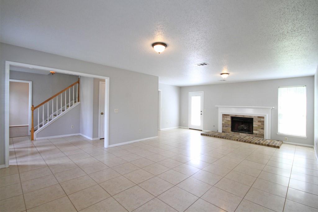 Spacious living room features fresh interior paint and lots of natural light.
