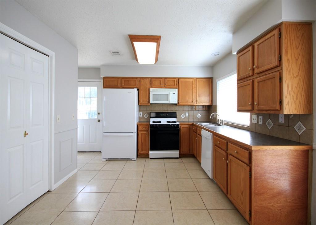 The kitchen has lots of cabinet space and two pantries for additional storage.