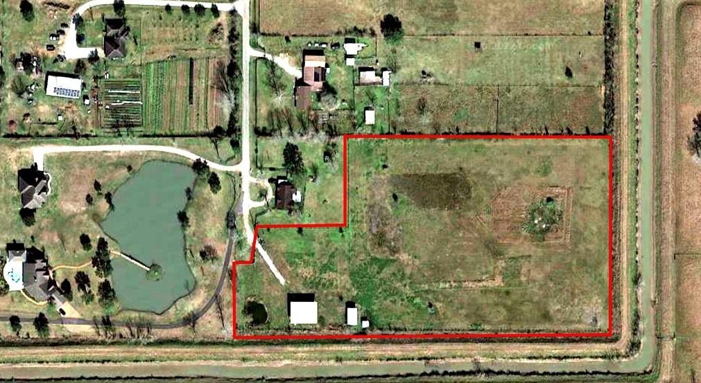 Amazing opportunity!! Over 7-acres of land perfect for building your farm or ranch home. It includes a 3000 SQFT metal structure that was elevated several feet from the street level with all city permits and inspections. It's ready for you to design your own barndominium home. Major improvements have been made to this property, including an iron entry gate with stone and brick pillars, a pond, fencing and an electrical post.  No back or side neighbors gives this unique property that private country feeling while still being close to all the conveniences of nearby grocery stores, shopping and schools.