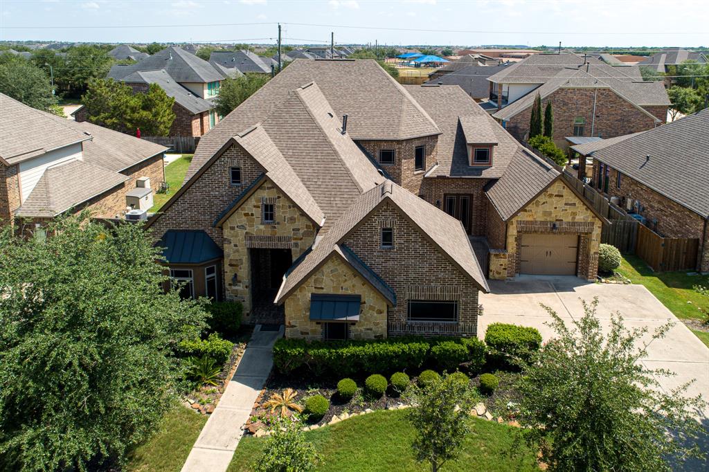 Located in the heart of the highly sought after Cinco Ranch South west community is this beautiful brick and stone elevation house with 4 bedrooms, 4.5 baths and 3 car garages. It also features media/entertainment room, game room and designated office. Its grand entryway and 2 story oval shaped foyer, welcome you to its soaring ceilings, open floor concept yet with designated spaces. The entertainers delight kitchen features rustic cabinetry for ample storage, rough cut granite counter tops, vast island and stainless steel appliances. Kitchen flows to breakfast area, nook, living room and gated courtyard. Huge primary bedroom suite has ample space for sitting and entertainment, dual vanity spaces, dual closet, tub and elegant walk-through shower. Also on first floor are two secondary bedrooms. The driveway allows for sufficient parking and access to courtyard. The huge two story patio and good sized yard also allows for a Texan-esque outdoor living. Zoned to exemplary Katy ISD schools.