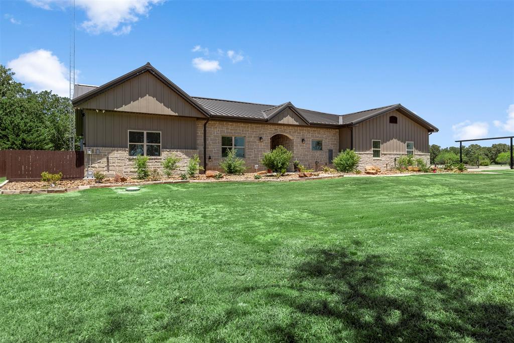 Over 7,200 sq ft of living, playing & working space on 4 acres w/ amazing shop near Messina Hof Winery. Fenced & cross-fenced property w/ 2 electric gates, pond, garden & horse shed w/ water. Shop is 3200 sq ft with electric & water, 4 bays, 1 drive-thru to additional parking in back and 2 covered carports. Main living (4 bed / 3 bath / laundry), secondary living (2 bed / 1 bath / laundry), mother-in-law quarters (1 bed / 1 bath / laundry) & 3+ car garage w/ storage are all under one roof, totaling 4,114 of heated & cooled space. Main living highlights include open concept living, dining & kitchen, coffered ceiling, oversized island w/ seating for 6, gas cooktop, stainless appliances, farmhouse sink, plus coffee & beverage bars with mini-fridge. Beautiful light-filled master suite with barn door, separate vanities, garden tub & shower are steps from laundry room w/ sink. Large backyard has expansive covered porches, outdoor kitchen & fire pit area -- great for entertaining.