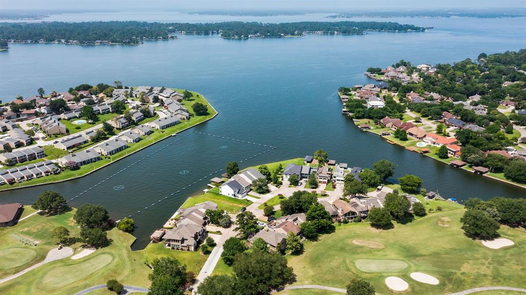 Incredible opportunity to own on a premier lakefront lot steps from the club in the gated golf course community of April Sound on Lake Conroe! The home was renovated and expanded in 2006 with a sprawling floorplan meticulously designed for those who love to entertain. The large split-level living room area includes floor-to-ceiling windows spanning the entire back side of the home with panoramic views of the lake. The kitchen has stone counters, custom cabinetry, a center island, stainless appliances & large pantry. Large primary bedroom with a sitting area & excellent views. Four spacious guest rooms are located on floors one, two, and three. The home will also include a game room, formal dining, sitting room, loft, and reception area. Other features include a whole home generator, elevator shaft, & wiring for sound & light automation. Exceptional backyard space with large covered patio and expanded deck, boat house with lift, newly replaced bulkhead, and plenty of space for a pool.