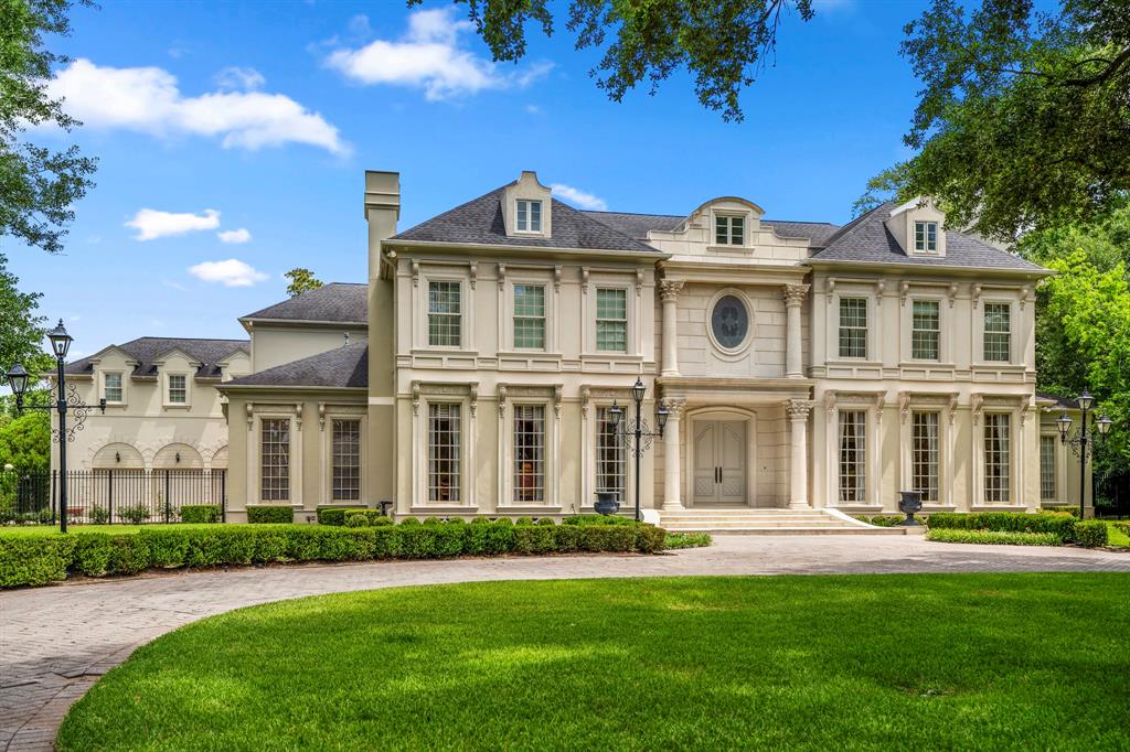 This custom estate is set upon 1.7 acres (per HCAD) and features meticulously manicured and wooded grounds. The rear yard features a covered pavilion and limestone deck flanking the sparkling pool appointed with delicate water features. The home is approached by way of imposing gates and a long circular driveway before reaching the dramatic entrance. Doors open to a two story rotunda with domed ceiling, drenched in natural light.