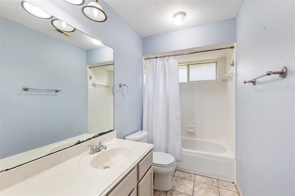 Secondary bathroom off of the living room. Shower/tub combo.