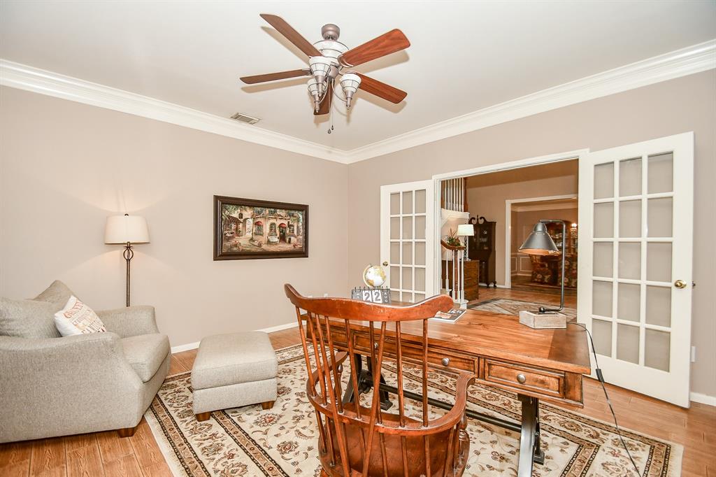 This completely restful study/home office, right off the main hallway, features hard wood floors? wood-look tile floors? with pale earth tones on the walls and classic crown molding. Delicate, traditional french doors create privacy, if desired.