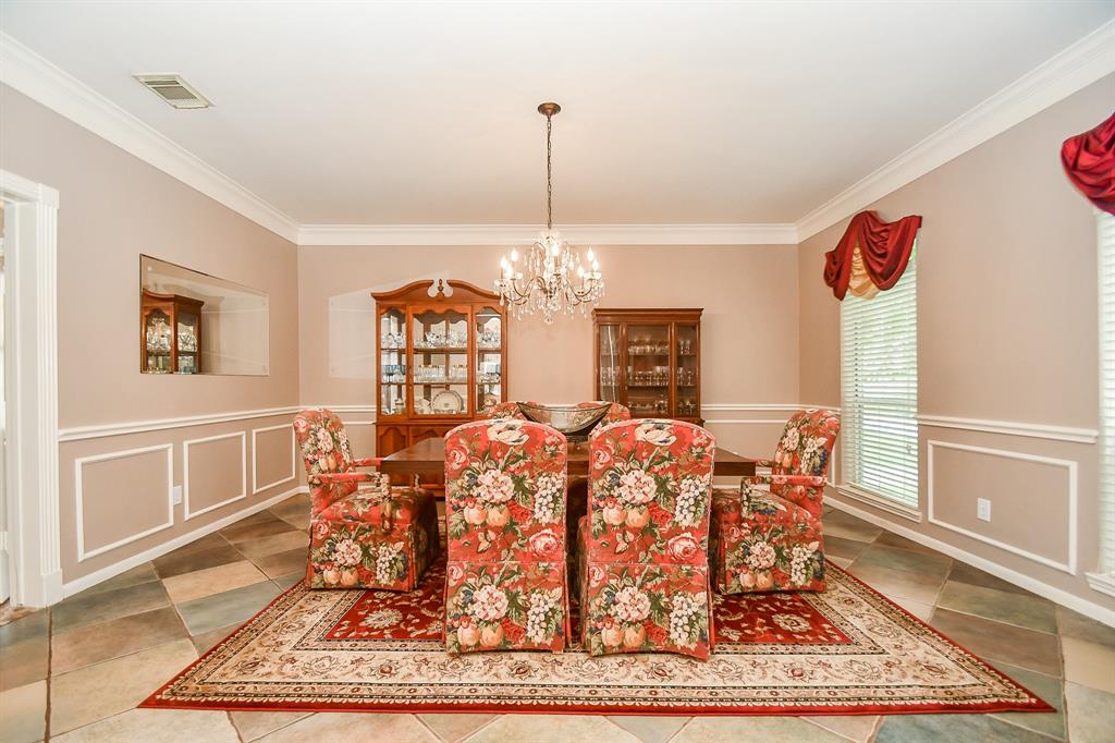 This amazingly spacious area is perfect as a formal dining room, with direct access to the chef's kitchen, left. This gorgeous area is bathed in exquisite tile flooring, with sophisticated wall accents and classic crown molding.