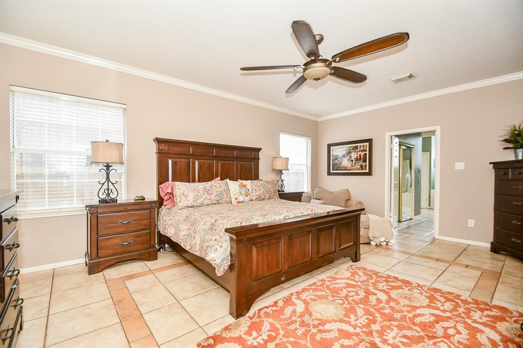 This is your unique primary suite, with exquisite custom tile flooring, and ensuite bath, peeking out, right.