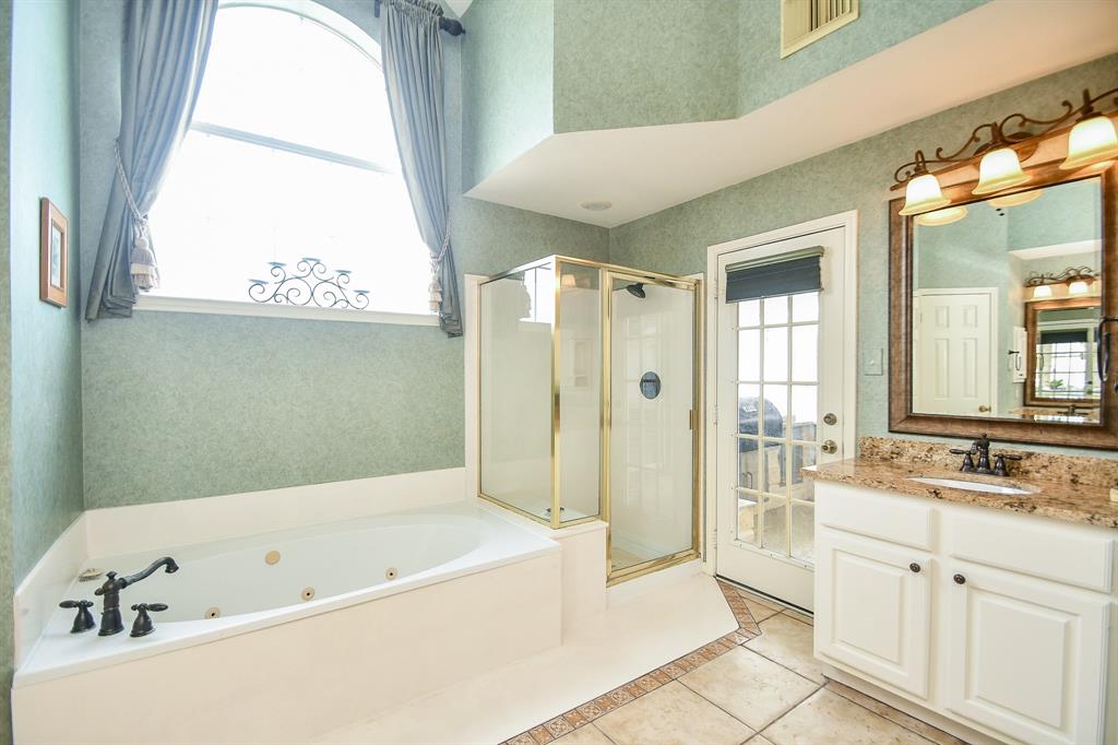 Take your pick: a long, languishing soak or a quick refresher in the glass enclosed shower, after move in day comes to a close!