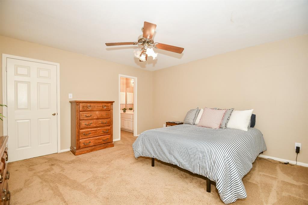 This spacious carpeted secondary bedroom enjoys its own ensuite bath, left.