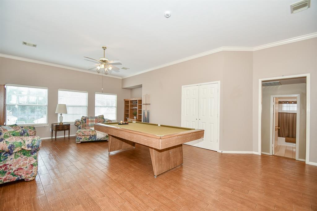 This extraordinary 2nd level 'gameroom' is designed for whatever you need/want it to be! Natural light from a wall of triple windows, shines on your activities and relaxing times. A convenient bathroom, right, is welcomed.