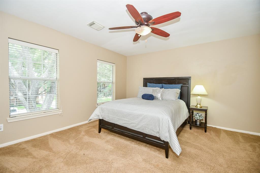 Great natural light fills this carpeted, secondary bedroom.