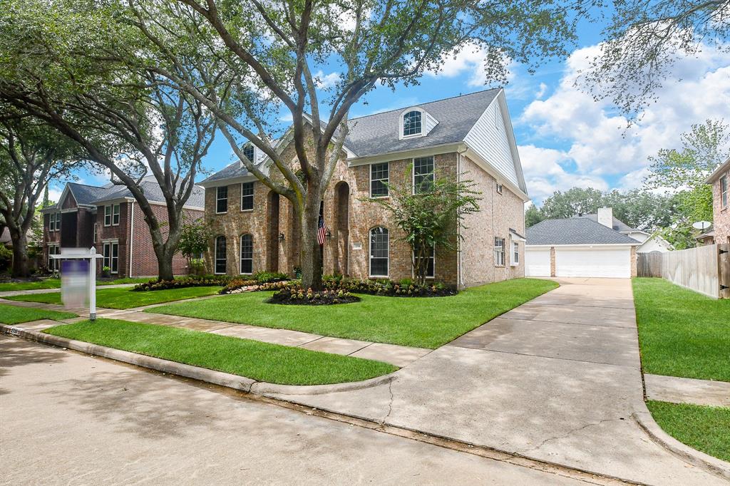 The pristine driveway naturally flows into the back areas of this home and access to the garages.