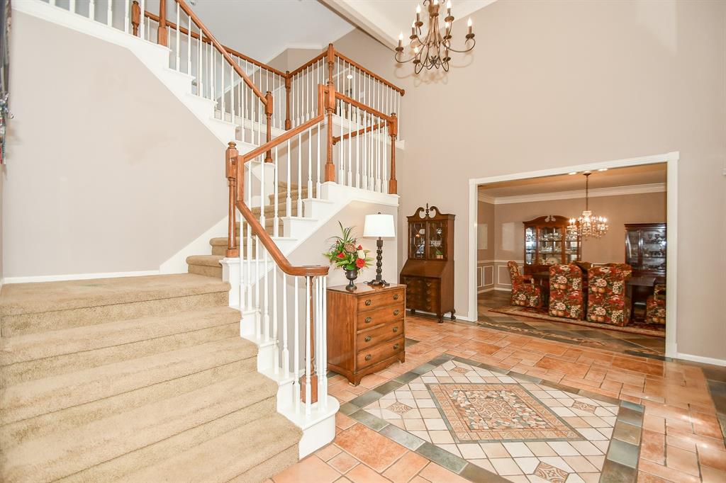 This whimsical, carpeted spiral staircase to the 2nd 'gameroom' level is a work of art, in itself, that greets family and guests, alike, as they enter the home from the front entrance. To the right, is your ultimate formal dining area.