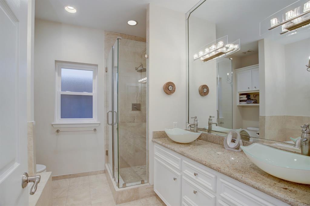 Primary bath with double sink and separate shower.