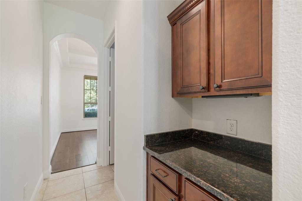 Wet bar connects to kitchen and dining.