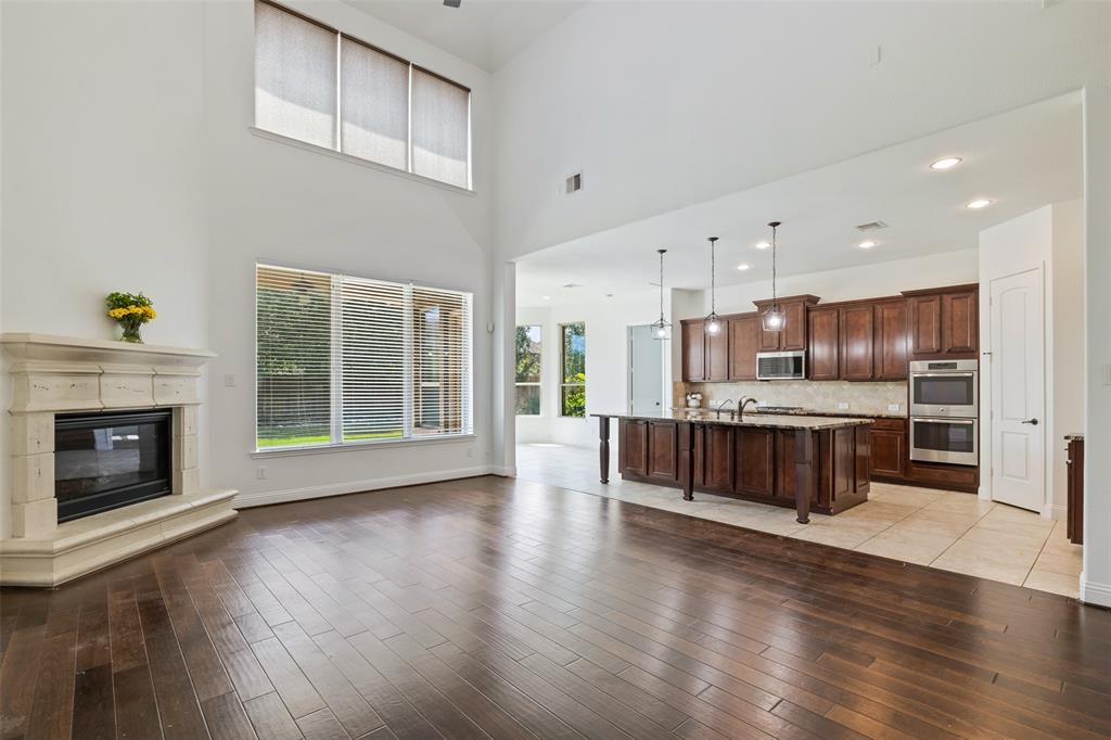 Open Plan living, kitchen, and breakfast area, with large windows and high ceilings, making it feel spacious and light.