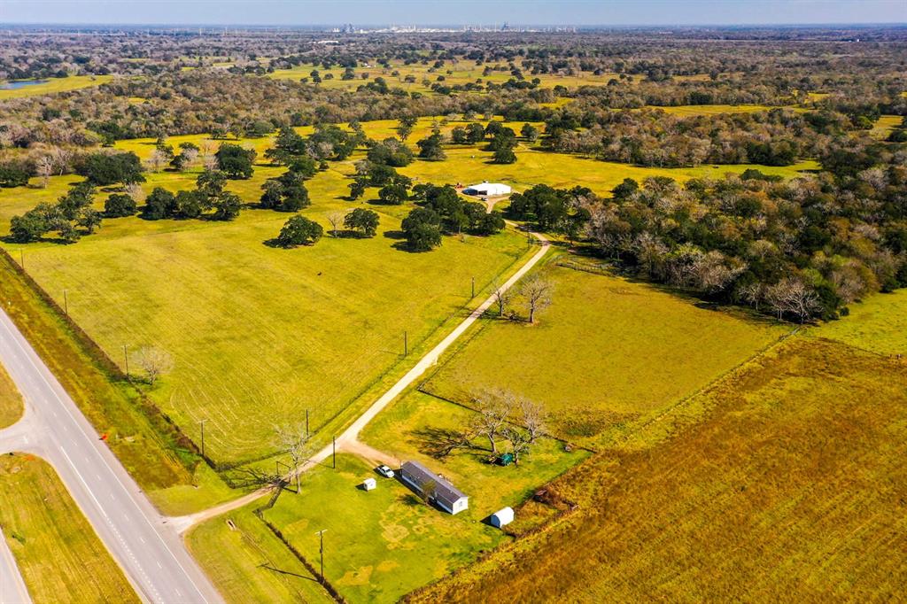 94 Acres with a full concrete floor barn with 2 leans 40x60 2 60x30 leans, and bathroom.  Beautiful mature oak and pecan trees scattered throughout the property and a pond.  2 Trailer houses, Fenced and crossed fenced with working pens. Deer, Hogs and other wildlife can be seen daily.  There are 2 entrances off HWY 35 and in Van Vleck ISD.  The property is only 68 Miles to Hobby Airport and 69 Miles to Downtown Houston, and 54 Miles to Sugarland, Tx.