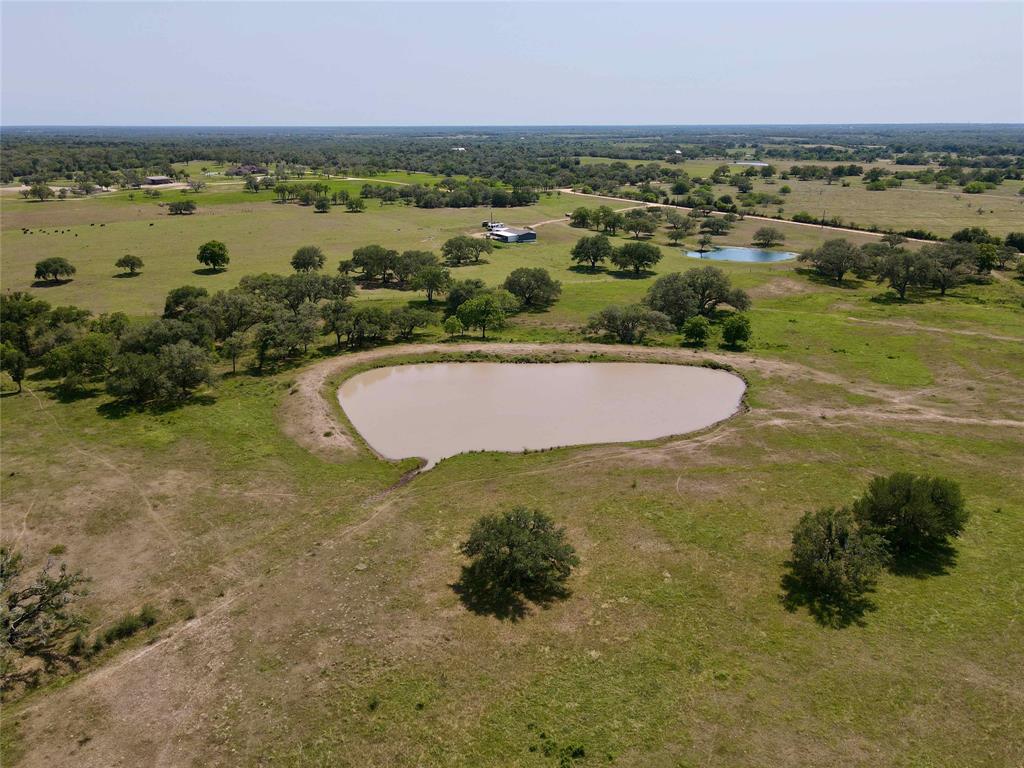 13 acres of rolling improved pasture, a hilltop, and a great pond!! A great building site sits atop the 1 acre pond, with a couple of oak trees to provide shade for your yard.  Come enjoy the country views! The property features a new entrance, improved grasses, and nearby electricity. There are light restrictions in place to protect your investment. This property is located just 7 miles southwest of Hallettsville near Sweet Home, just a short hour and a half drive from the Houston suburbs, 2 hours from Downtown Austin, and an hour 45-minute drive from San Antonio. Come build your dream home, or purchase now for a weekend getaway!