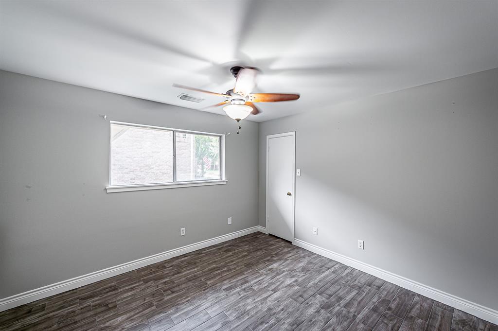 New flooring and fresh paint continue in secondary bedrooms.