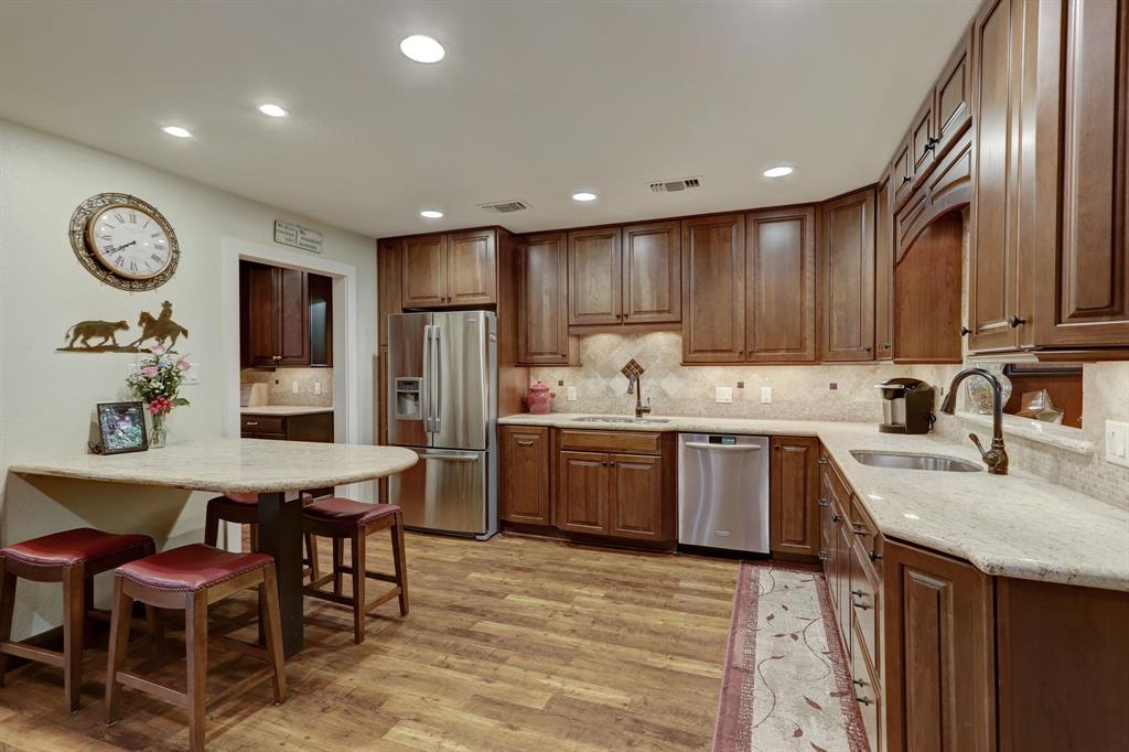 Double sink areas make food preparation for entertaining easy. The door to the left opens to a grand pantry with a wallop built-in absolving and a wall of cabinets and countertop.