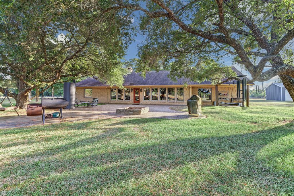 View of the great patio shaded by majestic oak trees. What a relaxing place to enjoy beautiful sunsets and breezy evenings!