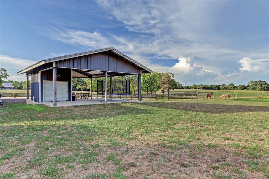 The covered pavilion overlooks the rolling pastures and tree lined lake. It is completed with an extra large storage closet and half bath. The sunsets that are breathtaking!!