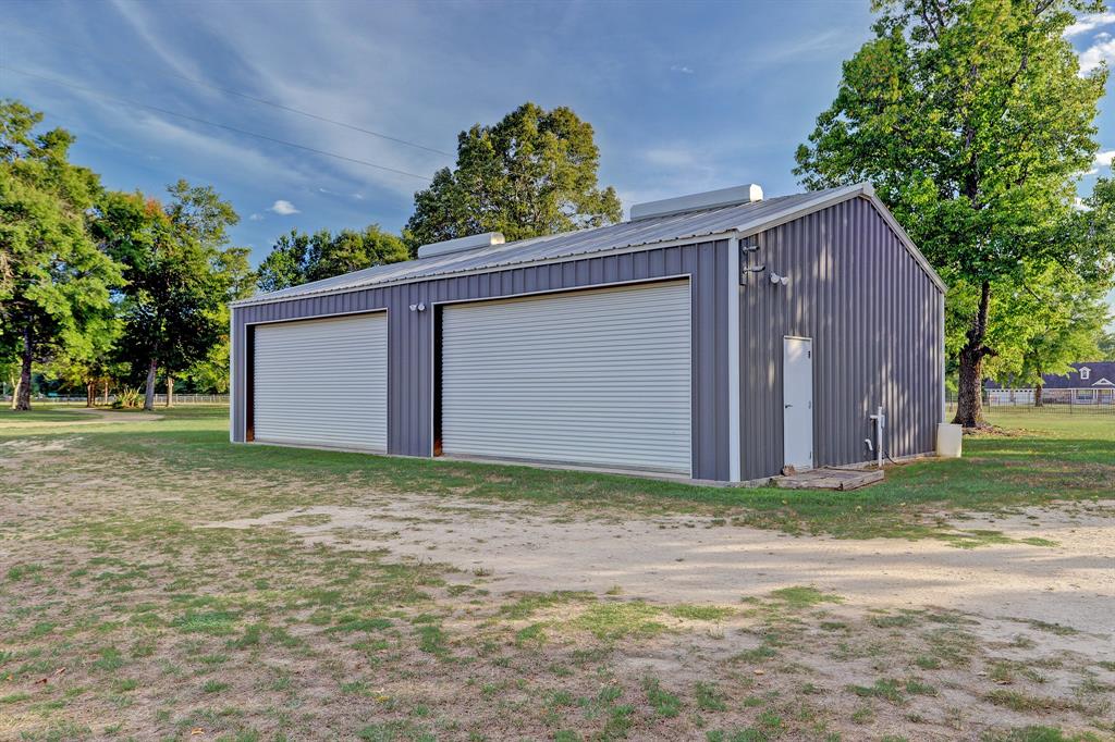 This secondary auxiliary building on concrete slab offers storage for vehicles and, or farming implements. It is well vented and lighted.