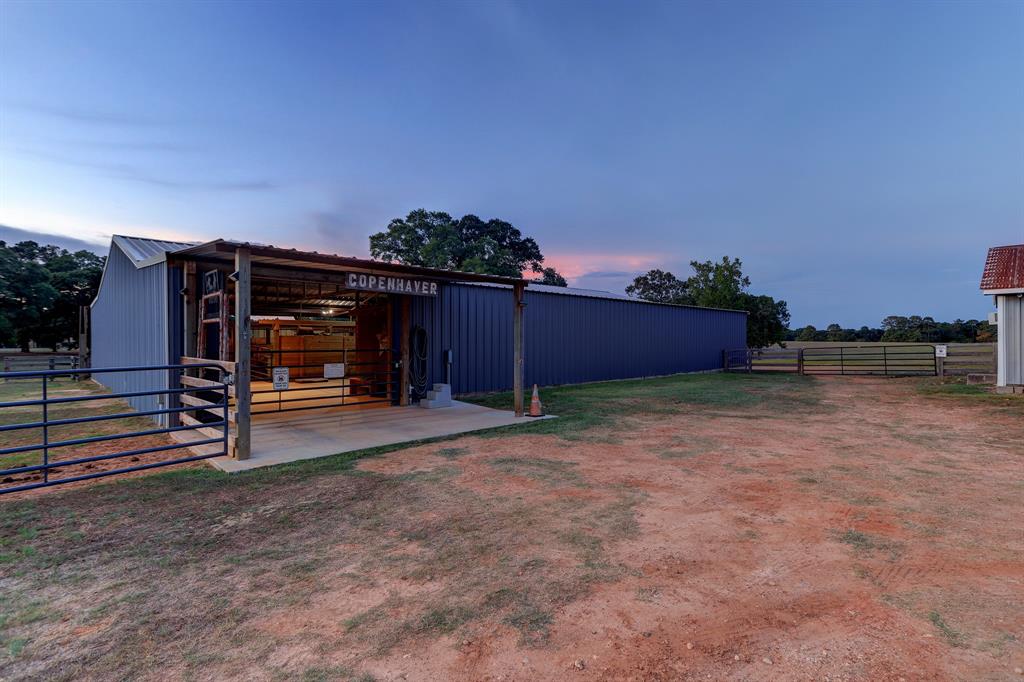 This is the state of the art barn with box stalls, climate controlled tack room, wide aisles, hay storage, covered entry and two wash areas. The turn out to the left is complete with a hot walker.