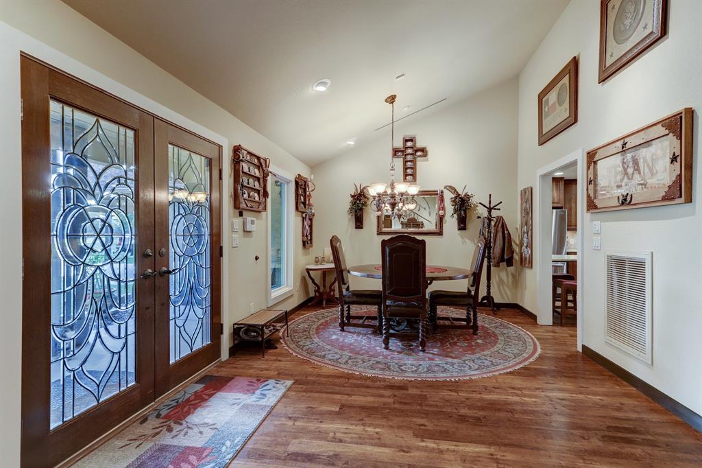 Leaded glass doors open into a welcoming entry. The doorway to the right opens to the gourmet kitchen.